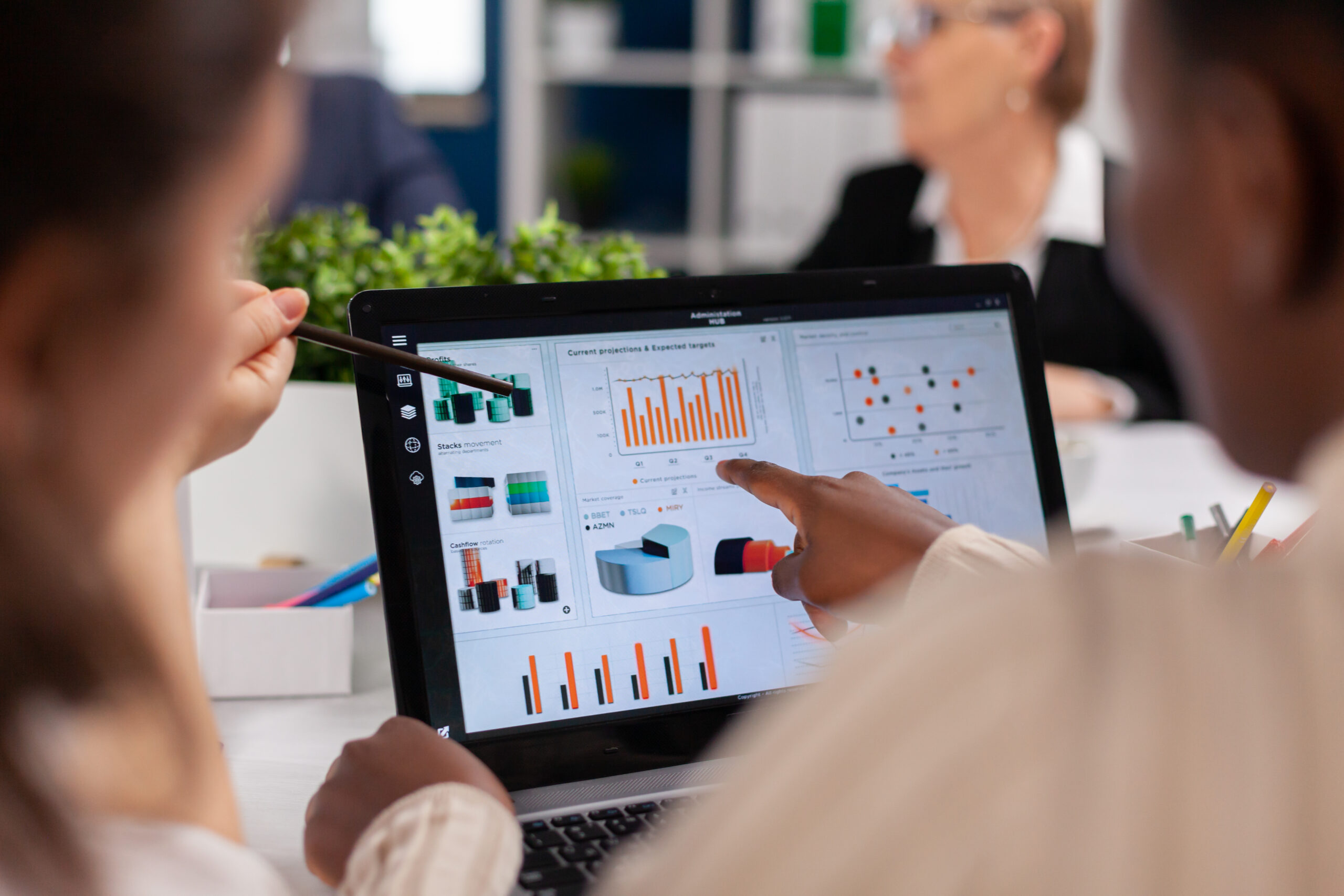 African american entrepreneur and coworkers analysing charts in conference room. Businesswoman discussing ideas with colleagues about financial strategy for new start up company working in brainstorming office.